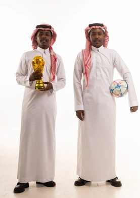 رجال سعوديون مع كأس كرة القدم والكرة