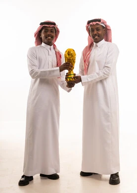 Saudi Men Holding World Cup Trophy Studio Shot