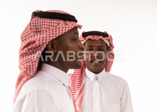 Saudi Men in Traditional Thobe and Red Shemagh