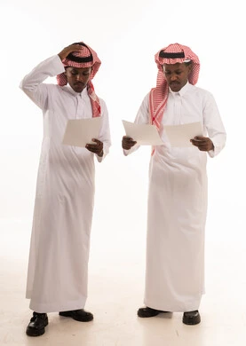 Saudi Men Reviewing Documents on White Background