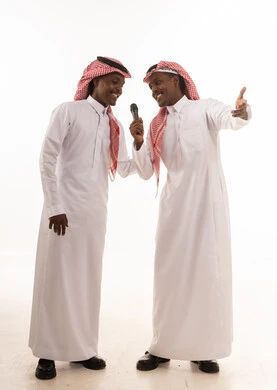 Saudi Men in Traditional Dress with Microphone