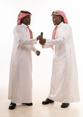 Saudi Men in Traditional Thobes with Microphone