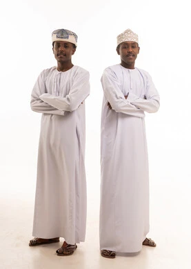 Two Omani Men in Traditional Dishdasha and Kummah