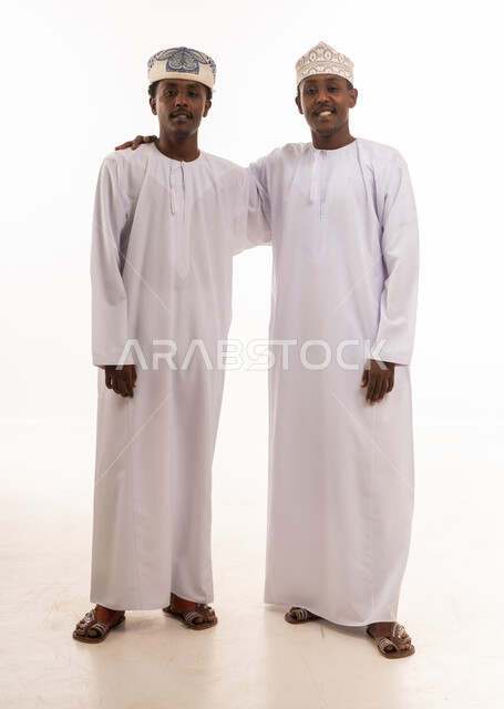 Two Omani Men in Traditional Dishdasha Dress