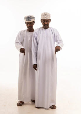 Two Omani Men in Traditional Dishdasha Pointing Down