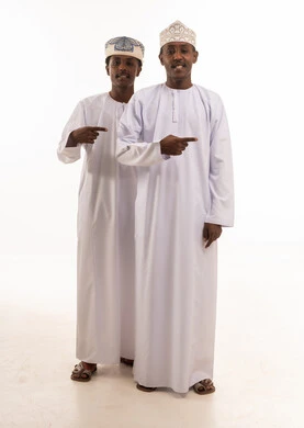 Omani Men in Traditional Dishdasha Pointing to Side