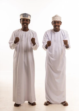 Omani Men in Traditional Dress Celebrating Victory