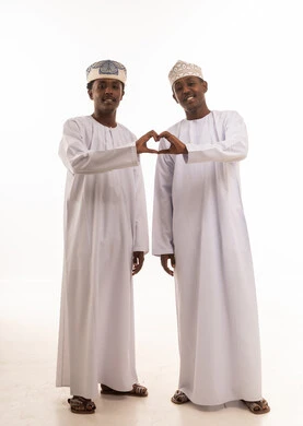 Omani Men in Traditional Dress Making Heart Gesture