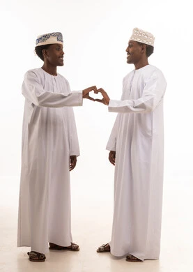 Omani Men in Traditional Dress Making Heart Shape