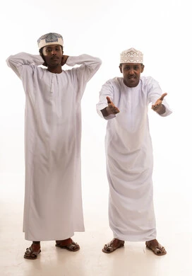 Omani Men in Traditional Dishdasha and Kumma