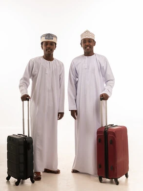 Omani Men in Traditional Dress with Travel Suitcases