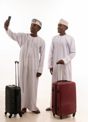 Omani Men with Travel Suitcases taking Selfie