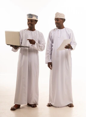 Omani Men with Laptop and Documents in Studio