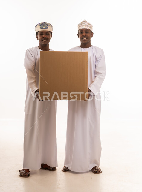 Omani Men Holding Large Cardboard Box on White Background