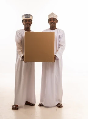 Omani Men Holding Large Cardboard Box on White Background