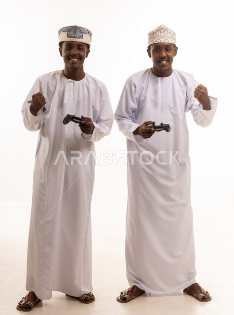 Omani Men Playing Video Games in Traditional Dress