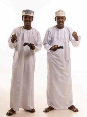 Omani Men Playing Video Games in Traditional Dress
