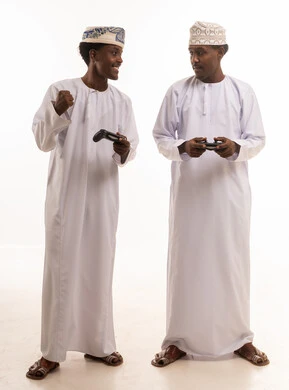 Omani Men Playing Video Games in Traditional Dress