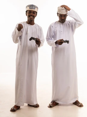 Omani Men Playing Video Games in Traditional Dress