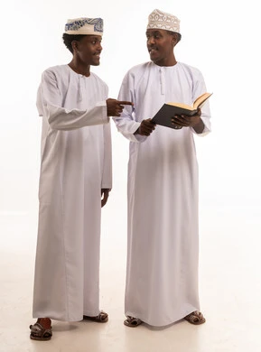 Omani Men in Traditional Dress Reading Book on White Background