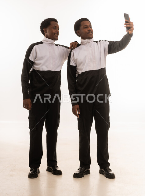 Omani Men Taking Selfie in Studio on White Background