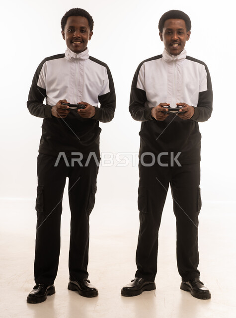 Omani Men Holding Gaming Controllers on White Background