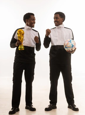 African Athletes Celebrating Victory with Trophy and Soccer Ball
