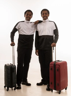 Omani Men Standing with Suitcases in Studio Background