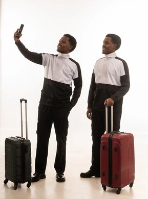 Omani Men with Travel Luggage Taking Selfie