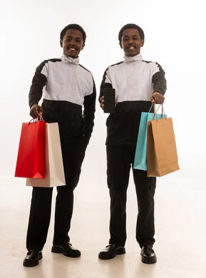 Omani Men with Shopping Bags and Smartphone in Studio