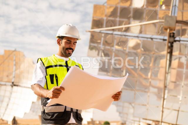 Middle Eastern Engineer Reviewing Solar Plant Blueprints