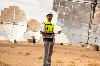 Saudi Engineer in Desert Solar Plant Holding Blueprint