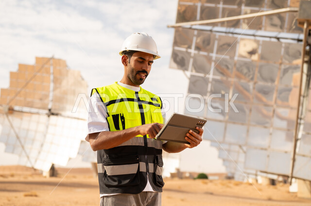 Middle Eastern Engineer Using Tablet at Solar Power Plant