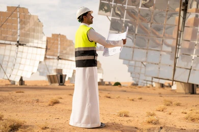 Saudi Engineer Reviewing Plans at Solar Power Plant