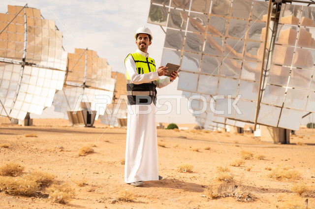 Saudi Engineer at Solar Power Plant with Tablet