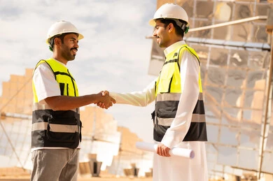 Arab Engineers Shaking Hands at Solar Power Plant