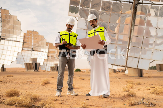 Saudi Engineers at Solar Power Station with Blueprints
