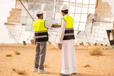 Saudi Engineers Reviewing Blueprints at Solar Power Plant