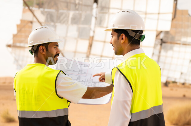 مهندسون سعوديون يراجعون مخططات محطة الطاقة الشمسية