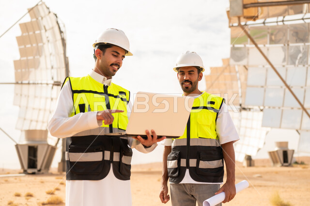 Saudi Engineers Working with Laptop at Solar Power Plant