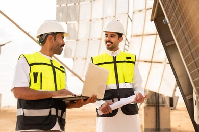 Saudi Engineers at Solar Power Plant with Laptop