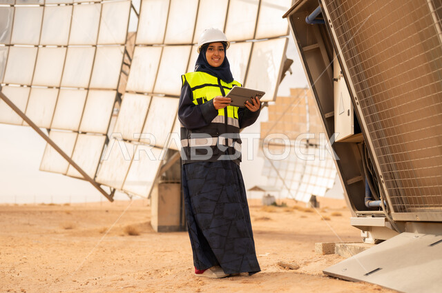 Saudi Female Engineer at Solar Power Plant with Tablet