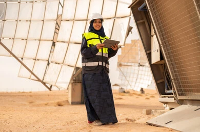 Saudi Female Engineer at Solar Power Plant with Tablet