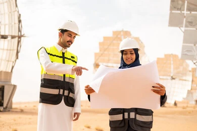 Saudi Engineers Reviewing Blueprints at Solar Farm