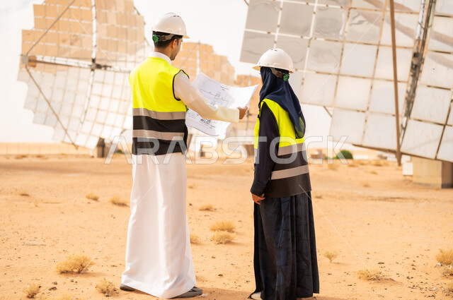 Saudi Engineers at Solar Power Station with Blueprints