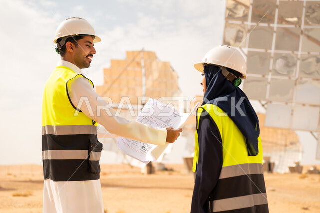 Saudi Engineers Discussing Blueprints at Solar Plant