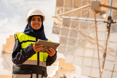 Saudi Female Engineer at Solar Power Plant with Tablet