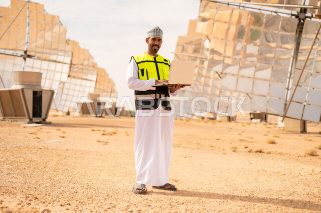 Omani Engineer at Solar Power Plant with Laptop