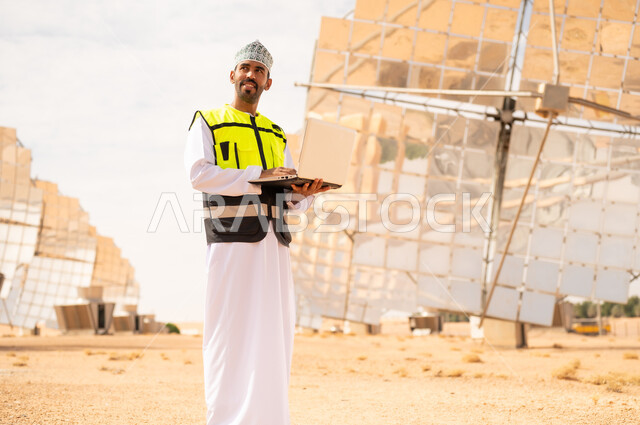 Omani Engineer with Laptop at Solar Power Plant