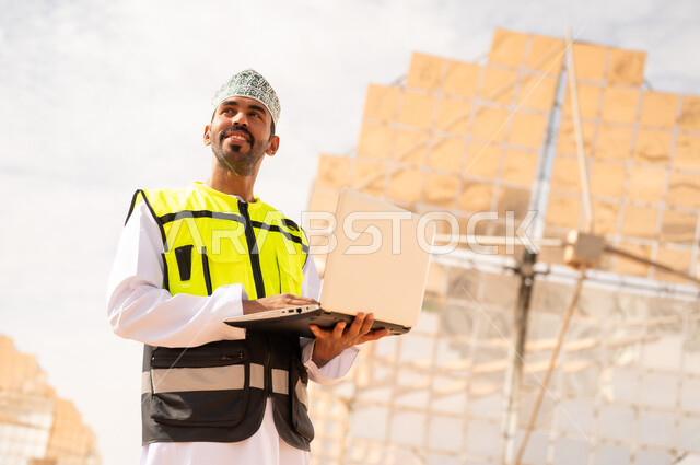 Omani Engineer with Laptop at Solar Power Plant